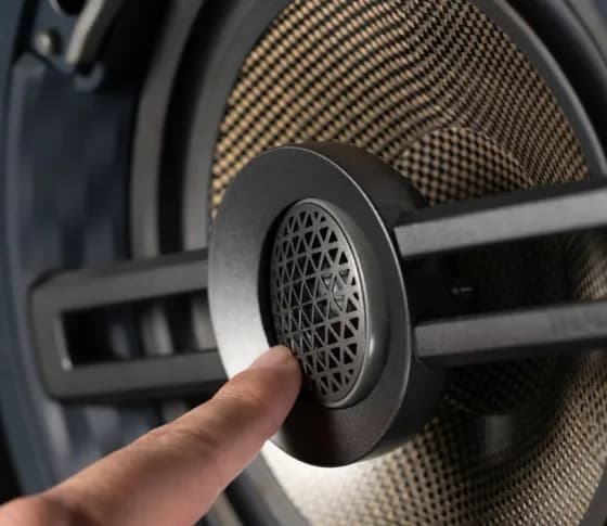 Triad speakers in a dark listening room.